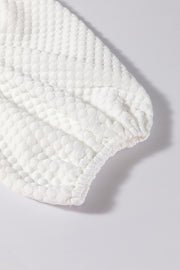 White textured quilted puff sleeve blouse with gathered cuff detail