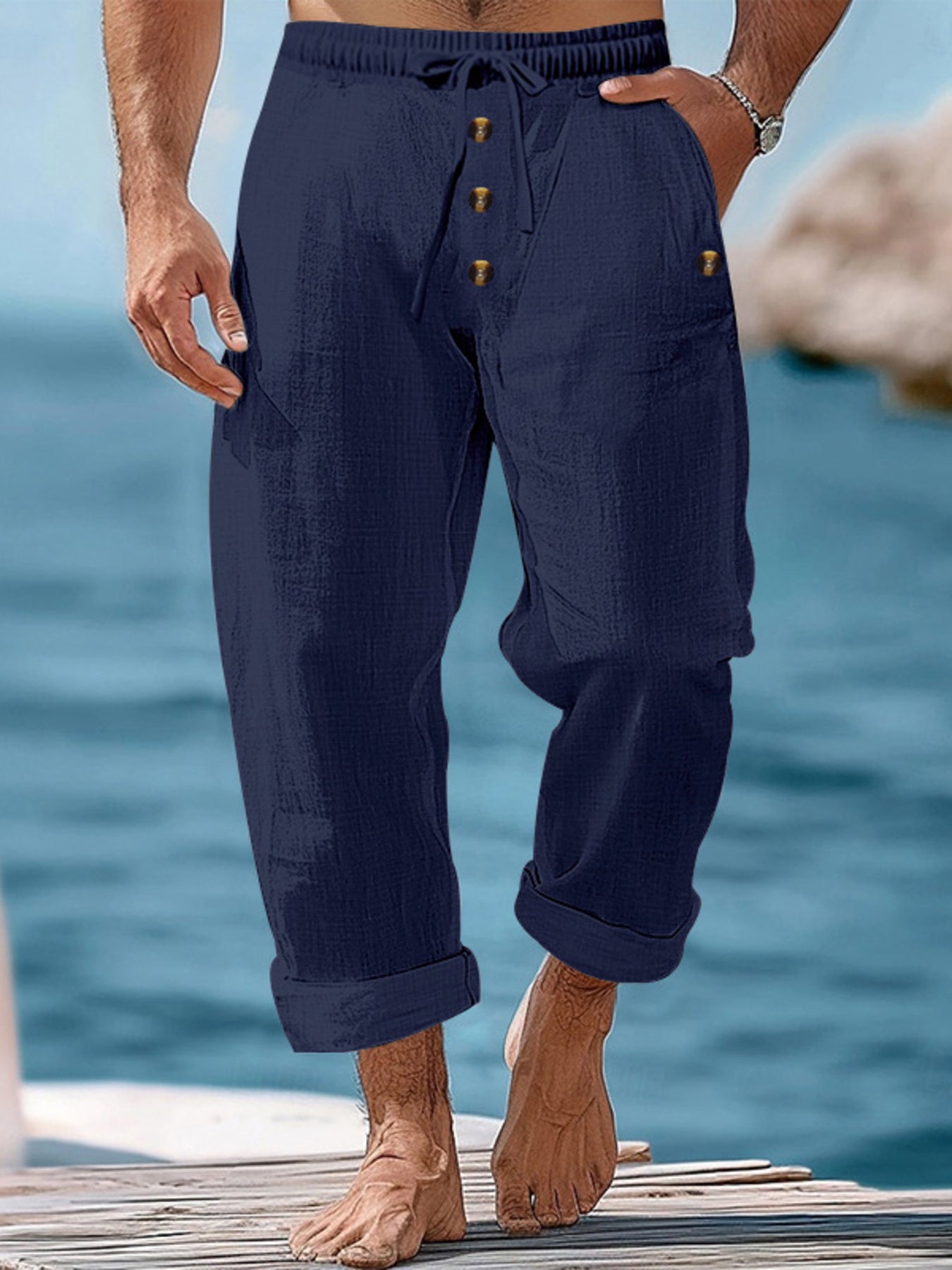 Navy blue relaxed fit drawstring sweatpants with button fly and cuffed hems.