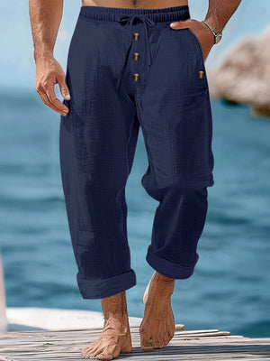 Navy blue relaxed fit drawstring sweatpants with button fly and cuffed hems.
