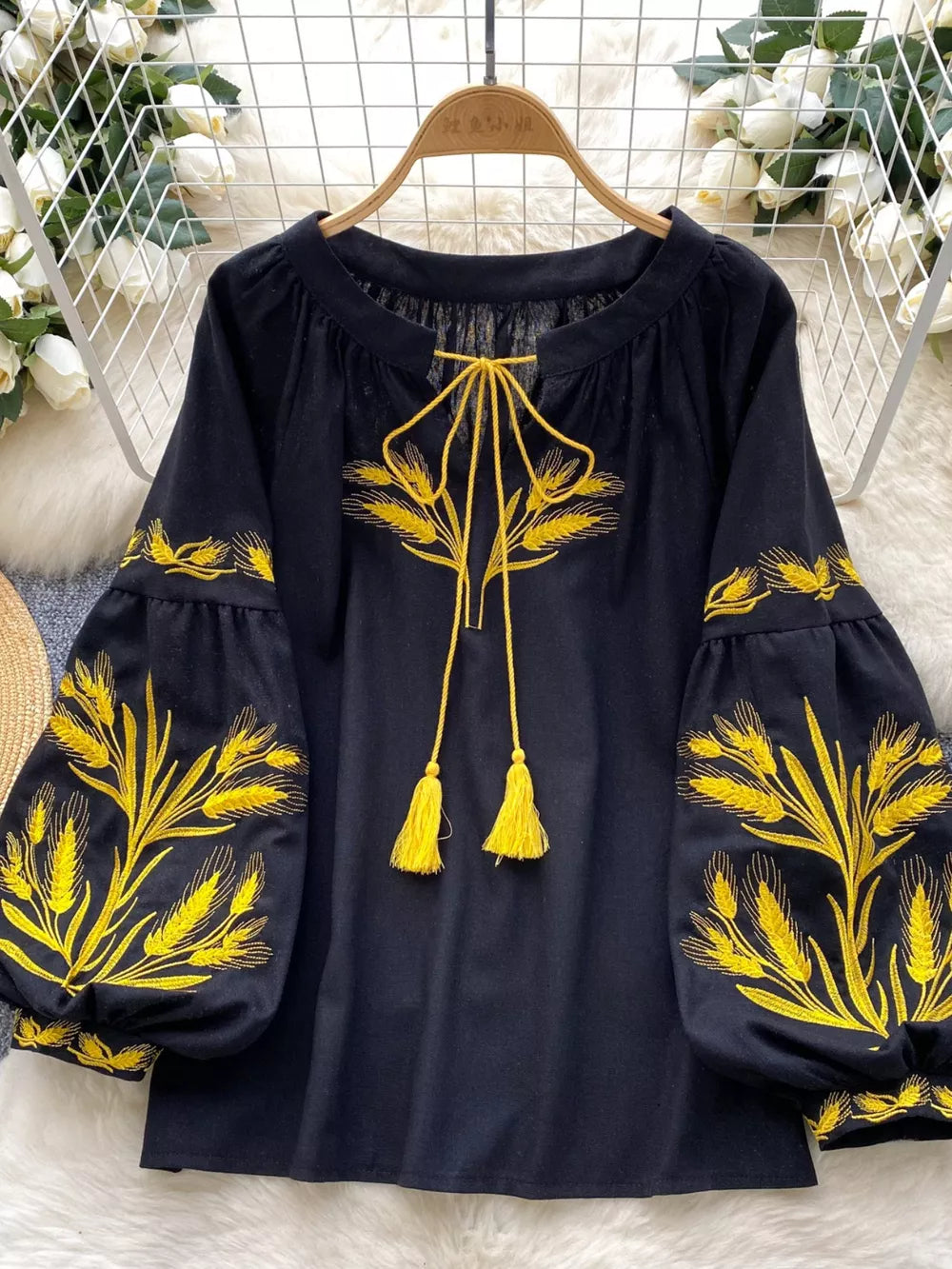 Black embroidered tie-neck blouse with yellow wheat detail and tassel ties.