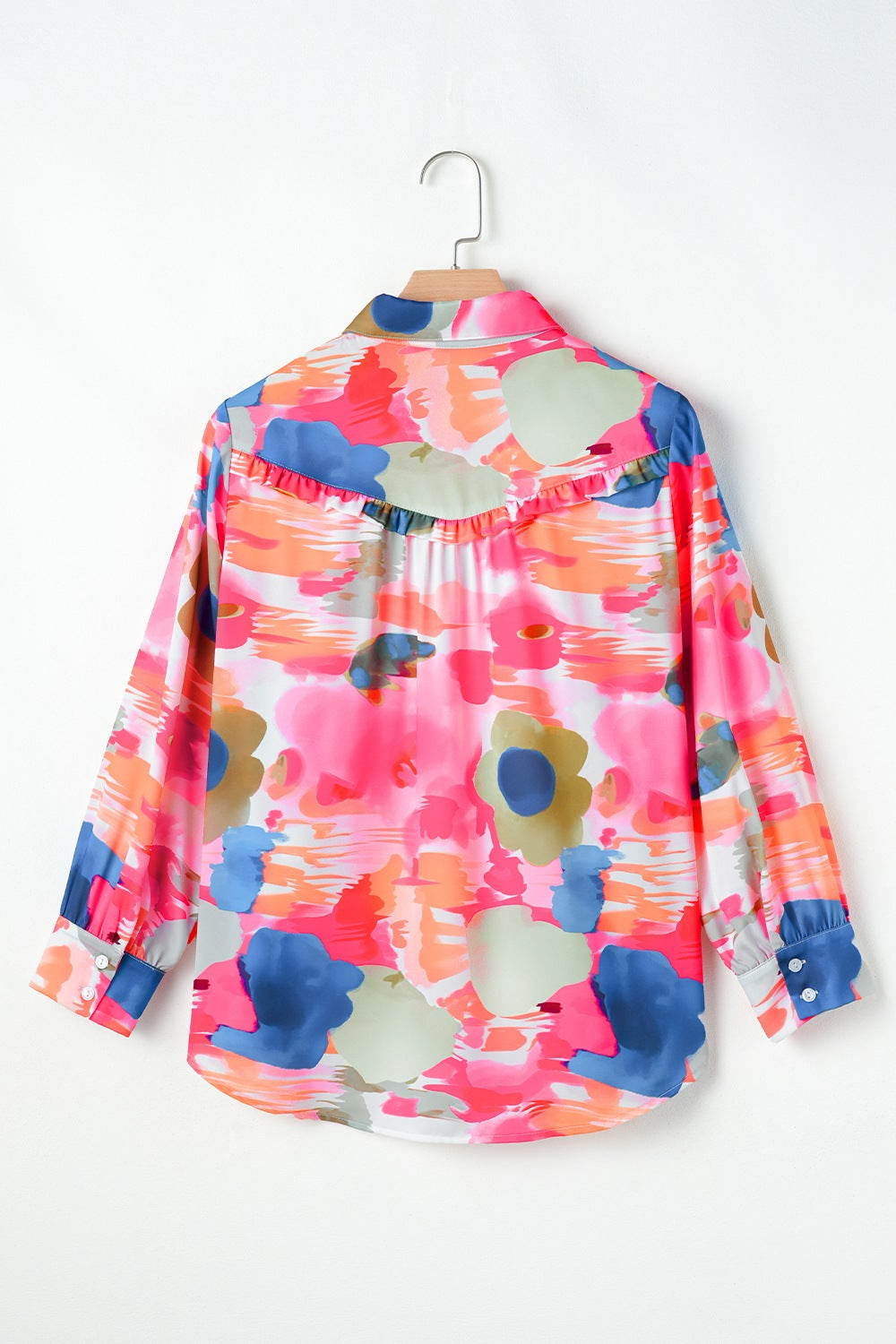 Painterly ruffle front blouse in pink with abstract floral print and long sleeves.