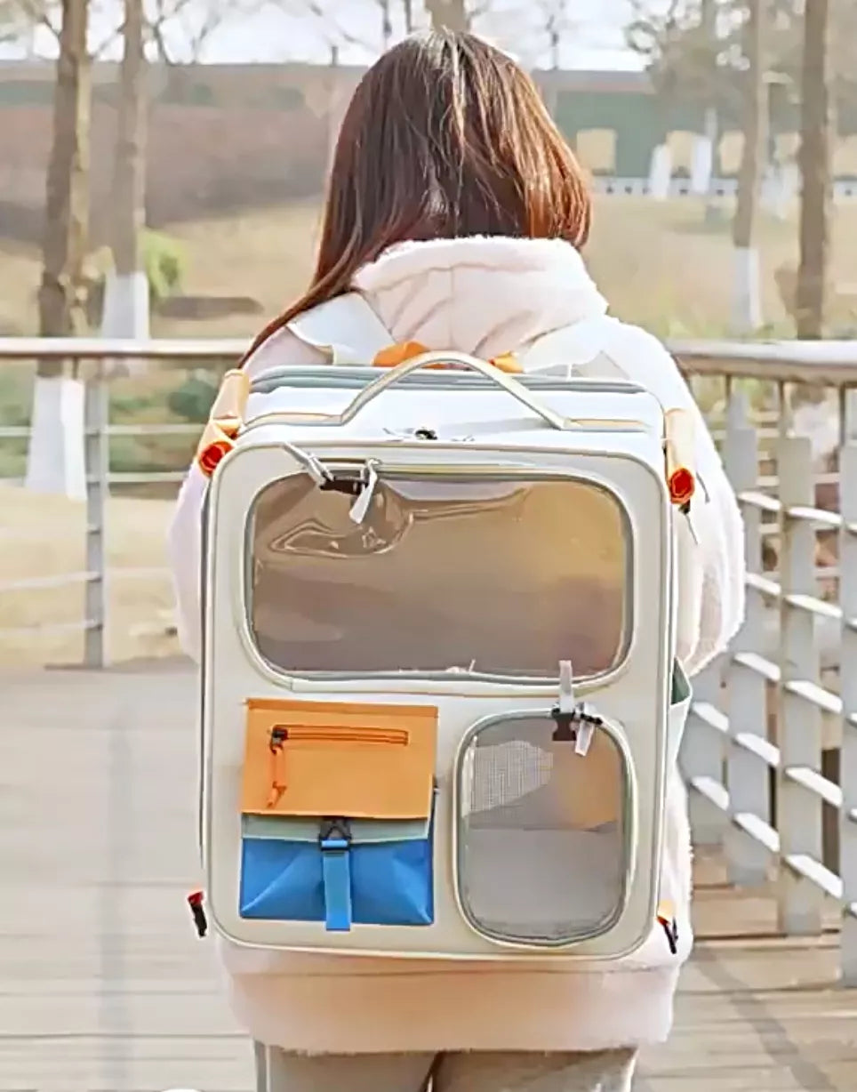 White transparent pet carrier backpack with orange and blue pockets