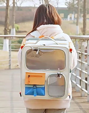 White transparent pet carrier backpack with orange and blue pockets
