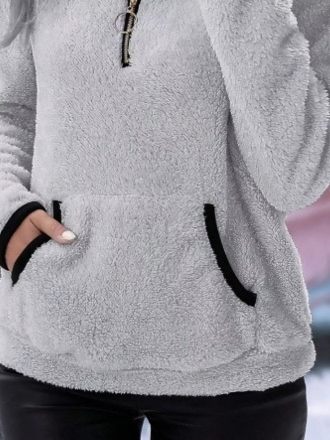 Light gray fleece quarter zip pullover with black trim and front pocket.