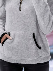 Light gray fleece quarter zip pullover with black trim and front pocket.