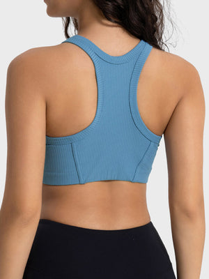Blue ribbed racerback crop top with contour stitching and racerback detail.