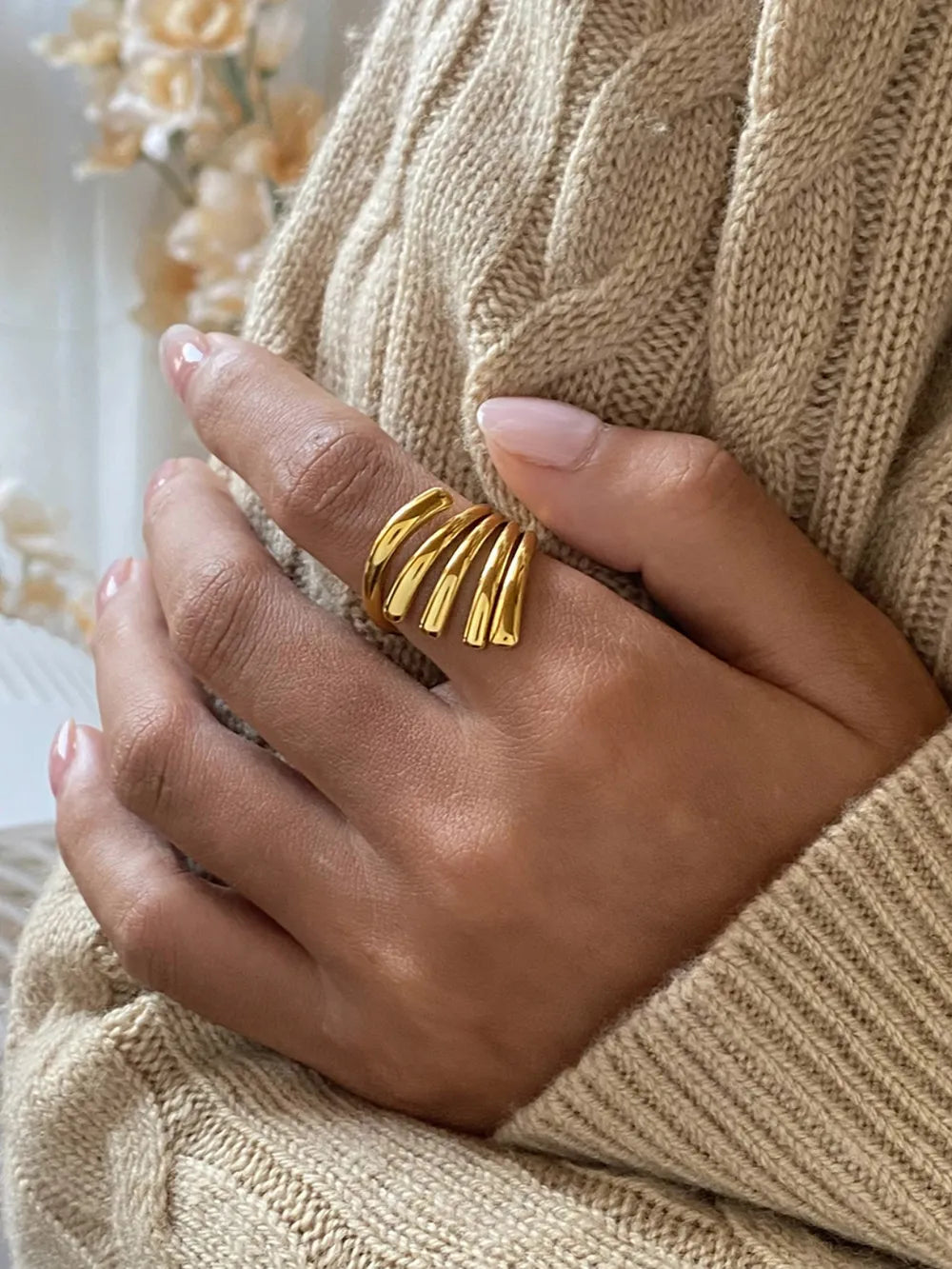 Gold-plated ribbed ring with a sculptural, multi-band design.