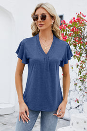 Dark blue V-neck blouse with pleated front and flutter sleeves.
