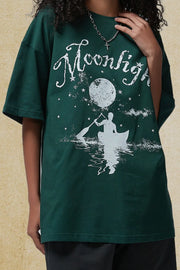Dark Green oversized tee with white "Moonlight" graphic of a person in a canoe under a moon and stars.