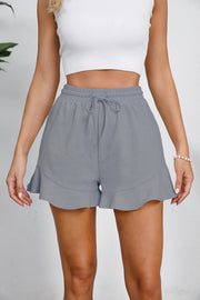 Gray linen blend shorts with drawstring waist and flounce hem detail