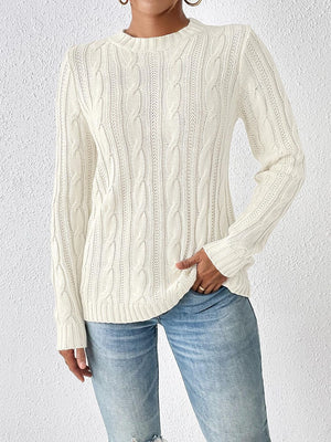 Ivory cable knit sweater with mock neck and long sleeves.
