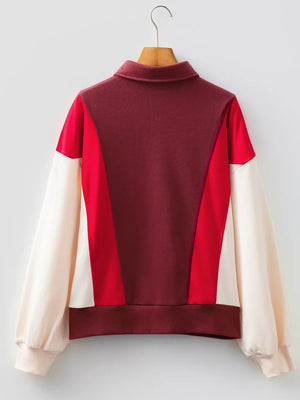 Oversized color block sweatshirt with a collared neckline and long sleeves in red, burgundy, and cream cotton.