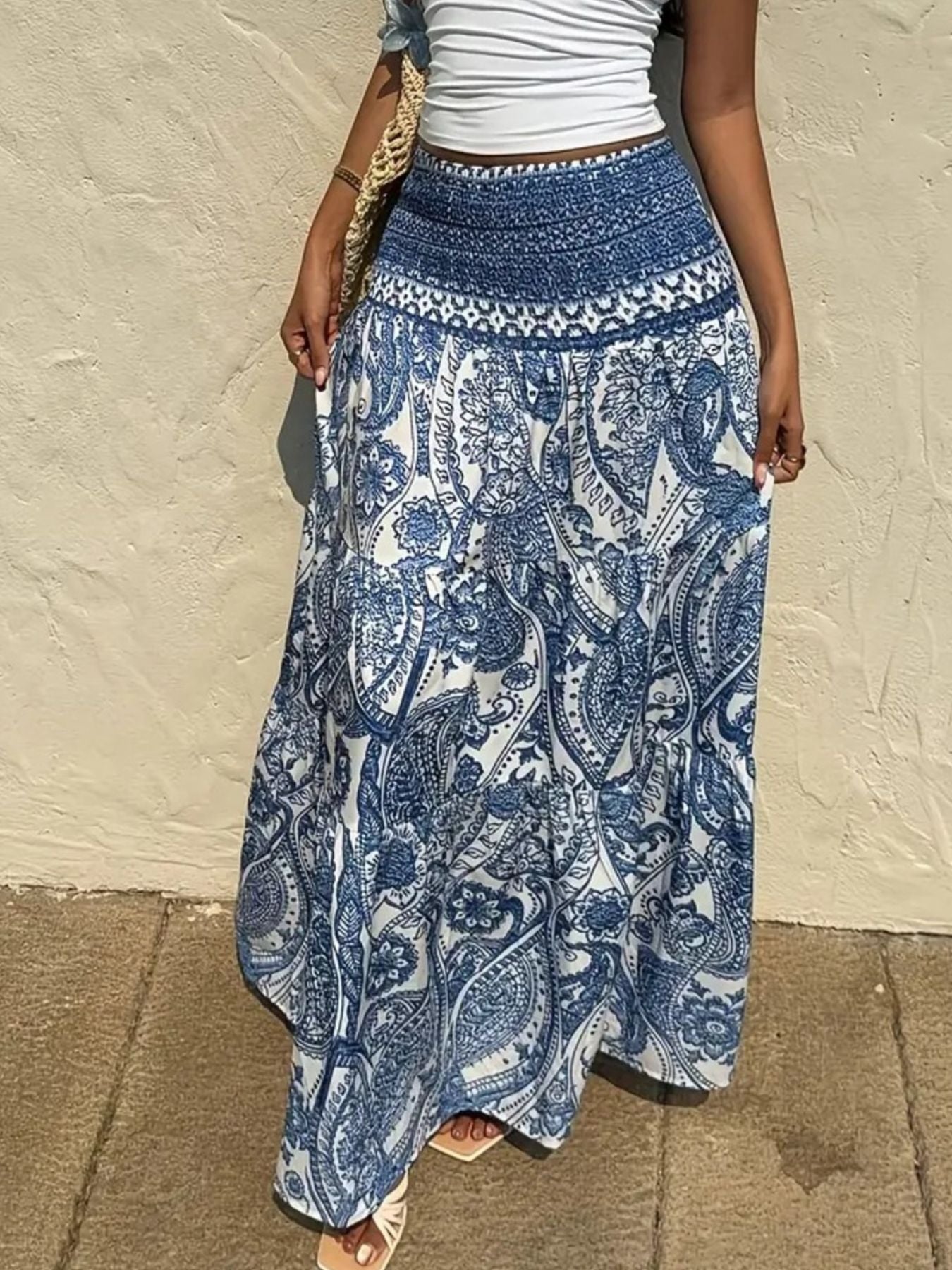 Bohemian paisley maxi skirt in blue with a smocked waistband and tiered flowy hem.