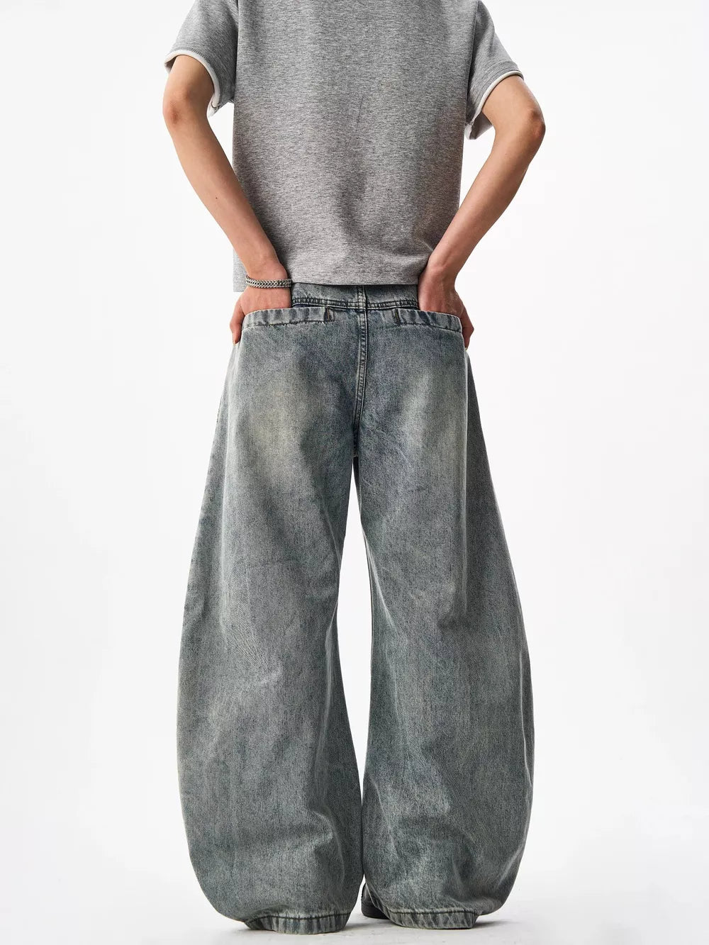 Belted wide-leg blue denim jeans with a baggy fit and cotton material.