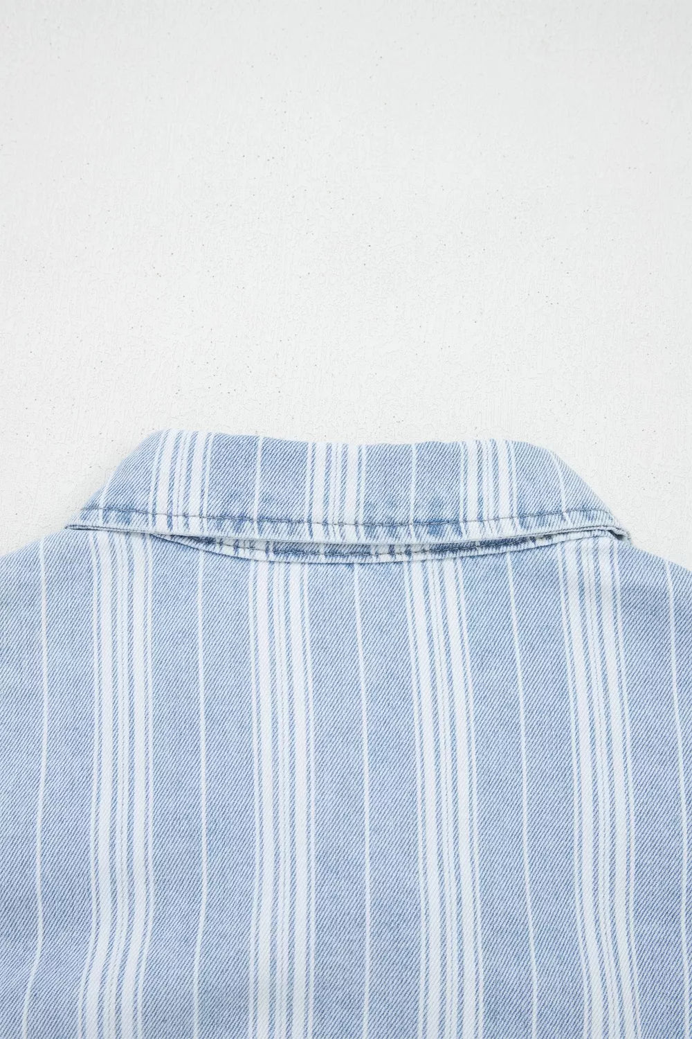 Relaxed denim shacket with blue and white vertical stripes and a collar detail.