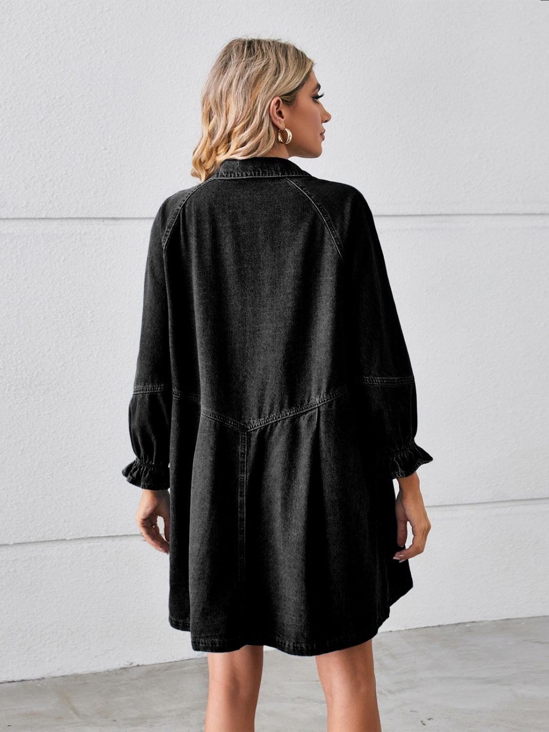 Black denim shirtdress with ruffled cuff sleeves and a gathered skirt.