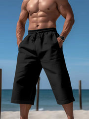Black relaxed fit drawstring cropped sweatpants with pockets.