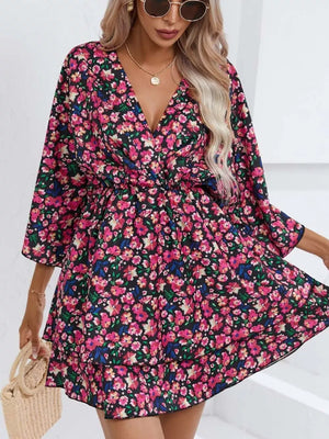 Floral ruffle hem mini dress in black with pink and blue flowers, V-neck, 3/4 sleeves, tiered skirt.