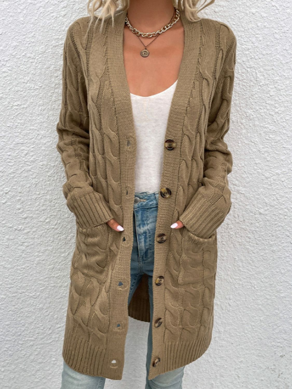 Tan cable knit button-down cardigan with pockets and a V-neck.