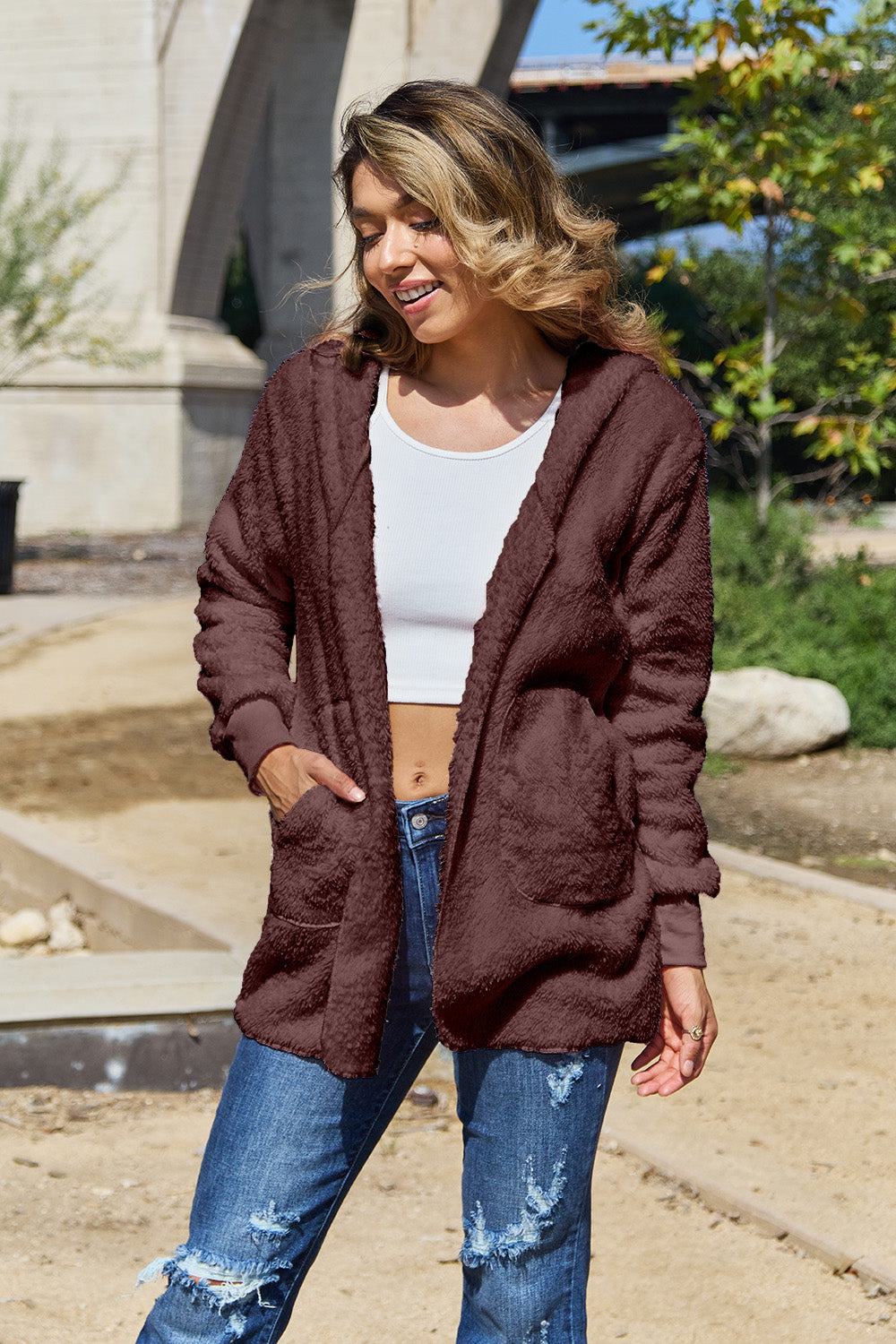 Plush hooded cardigan jacket in burgundy with open front and pockets.