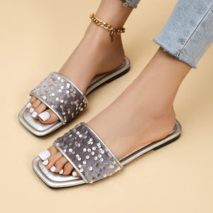 Silver sequined open-toe slide sandals with a velvet band and square toe.