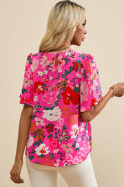 Hot pink floral blouse with flutter sleeves and keyhole back detail.