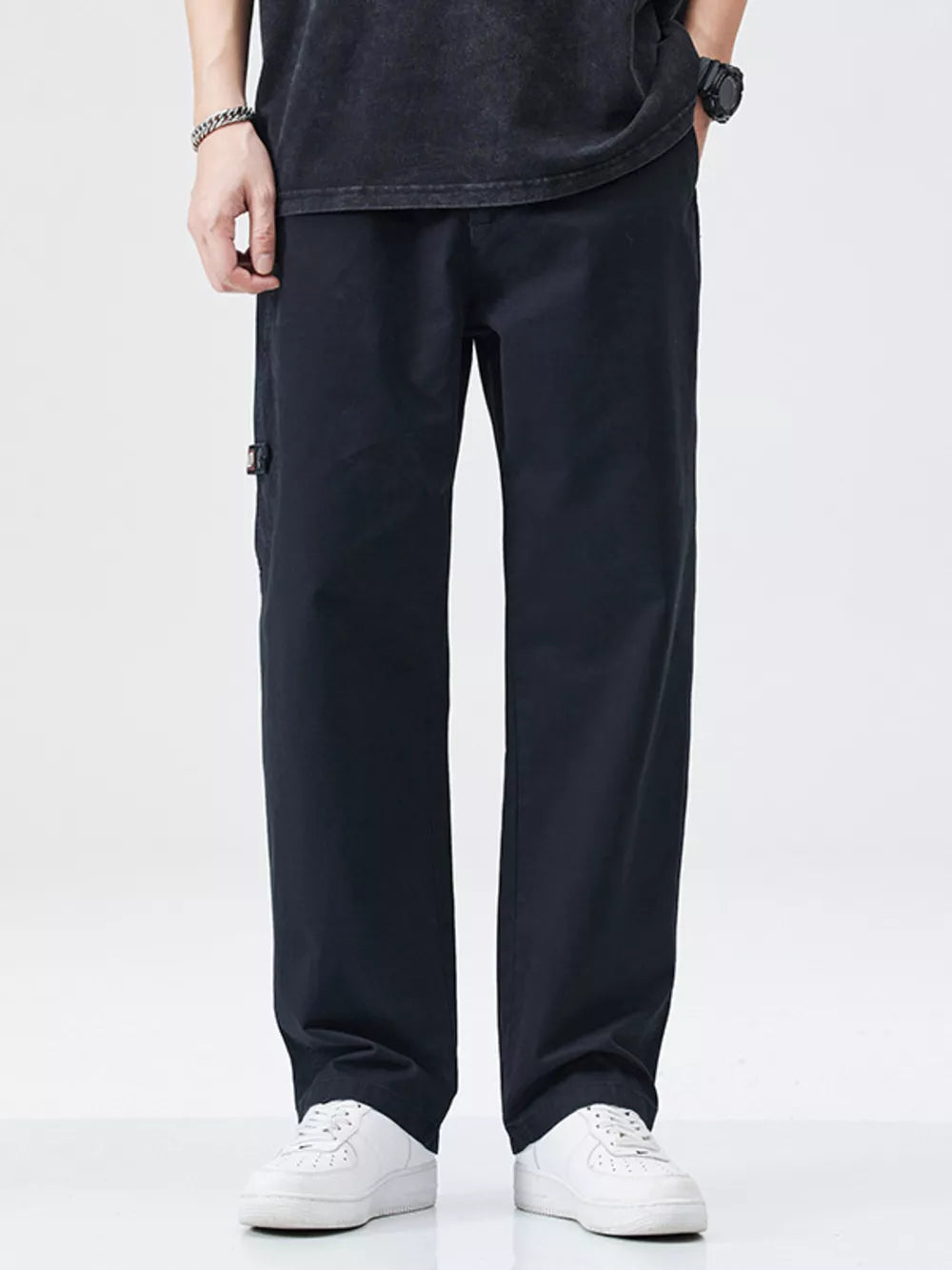 Men's black loose-fit cargo pants with utility pocket detail.