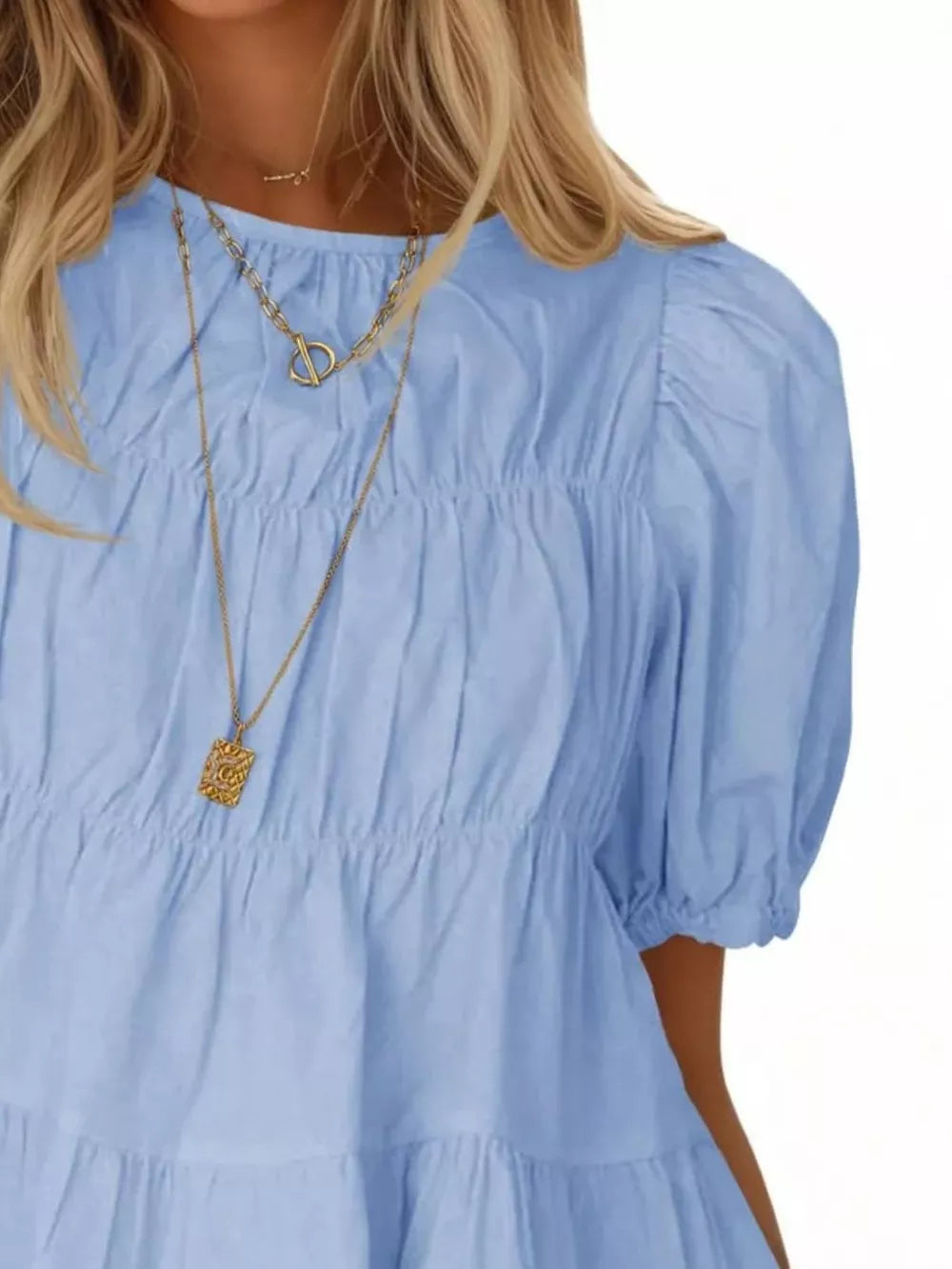 Sky blue maternity blouse with puff sleeves, ruffled tiers, and smocked bodice detail.