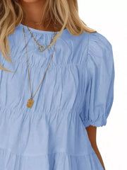 Sky blue maternity blouse with puff sleeves, ruffled tiers, and smocked bodice detail.
