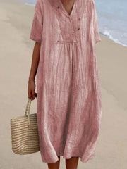 Pink V-neck casual midi dress with short sleeves and textured fabric.