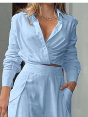 Light blue polyester two-piece set with pocketed pants and a ruched, collared shirt.