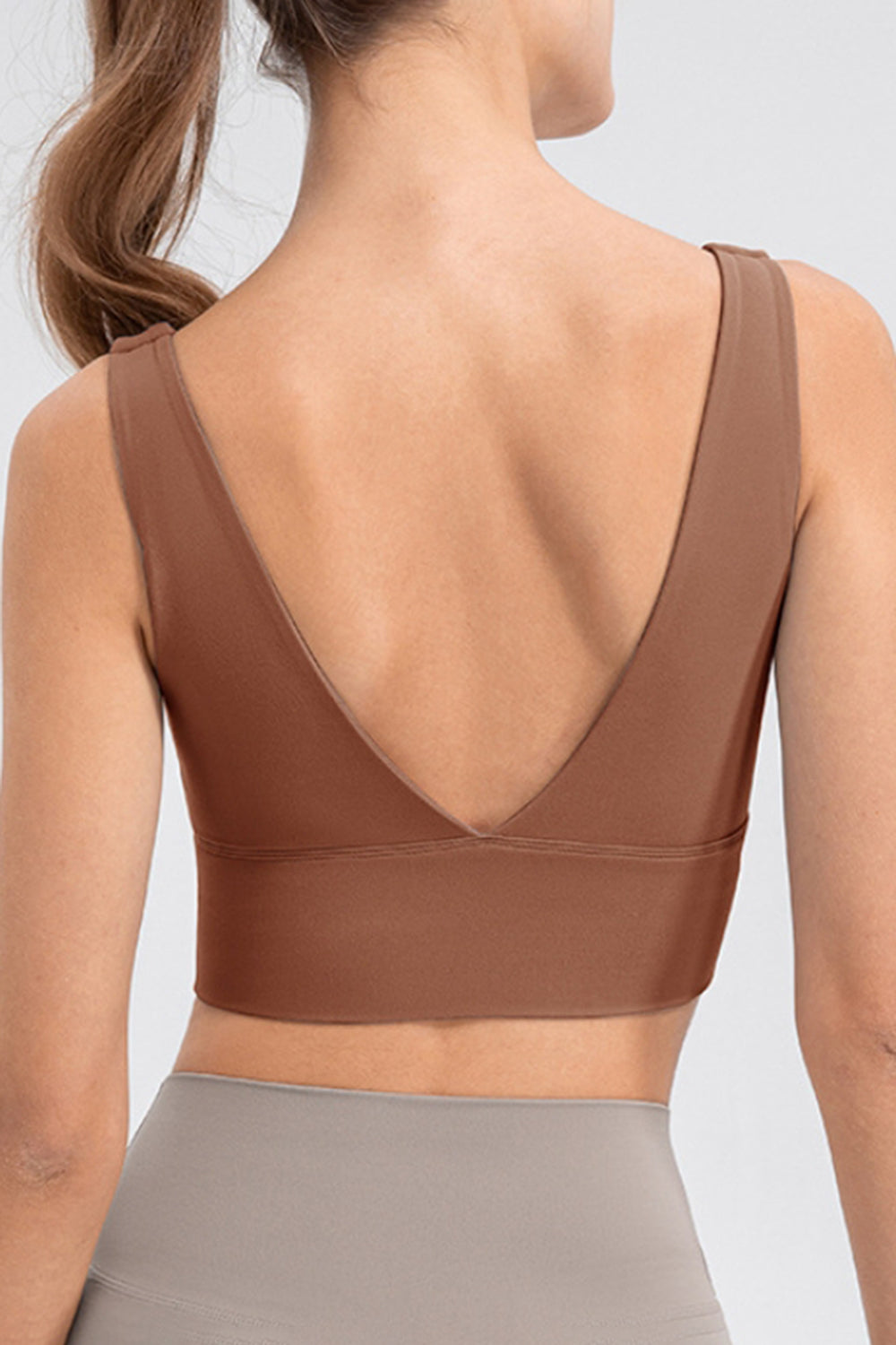 Sculpted backless crop top in caramel with a deep V-neckline and wide band.