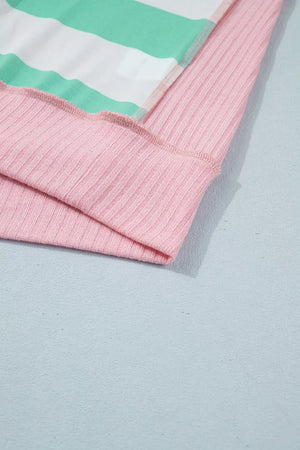 Oversized t-shirt with horizontal stripes in green and white, and pink ribbed cuffs and hem.