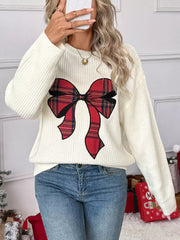 Cream ribbed knit sweater with a red plaid bow detail, crew neck, long sleeves.
