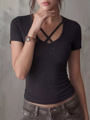 Black fitted t-shirt with crossover V-neck and subtle sparkle detail.