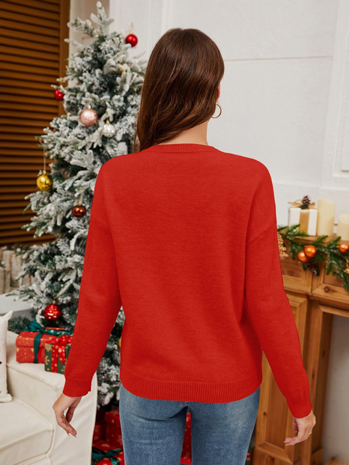 Orange-red acrylic knit sweater with long sleeves and crew neck, festive holiday style.