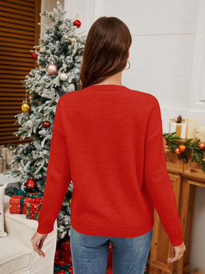 Orange-red acrylic knit sweater with long sleeves and crew neck, festive holiday style.