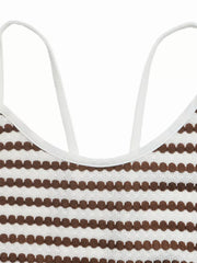 Halter neck midi dress with brown and white stripe pattern and textured detail.