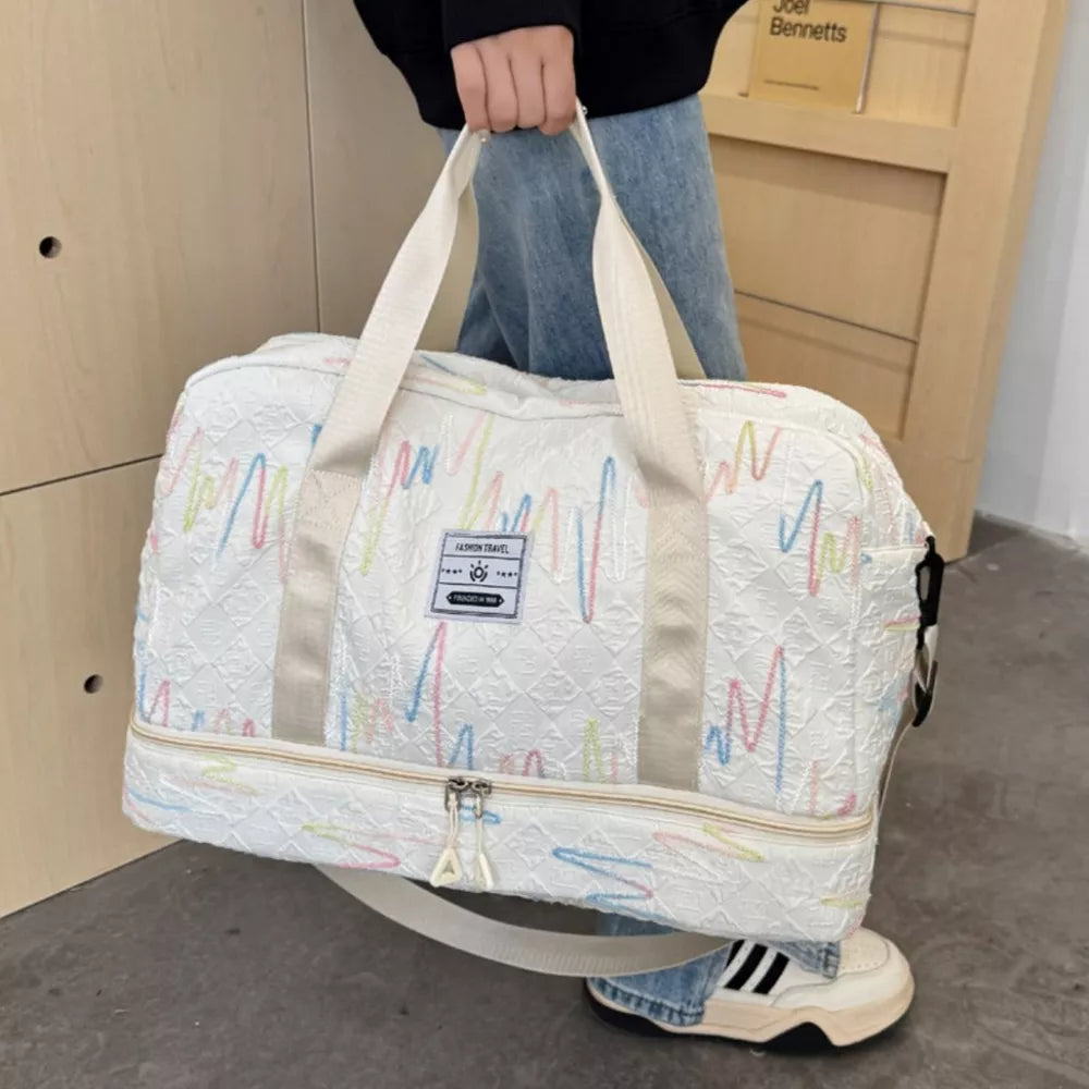Textured off-white duffel bag with colorful wave pattern and dual handles.
