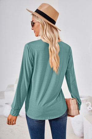 Teal long sleeve jersey top with gathered square neckline and curved hem.