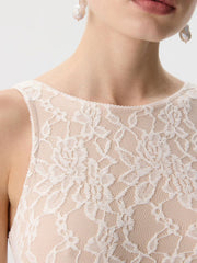 Beige sheer lace tank top with floral pattern and scalloped neckline.