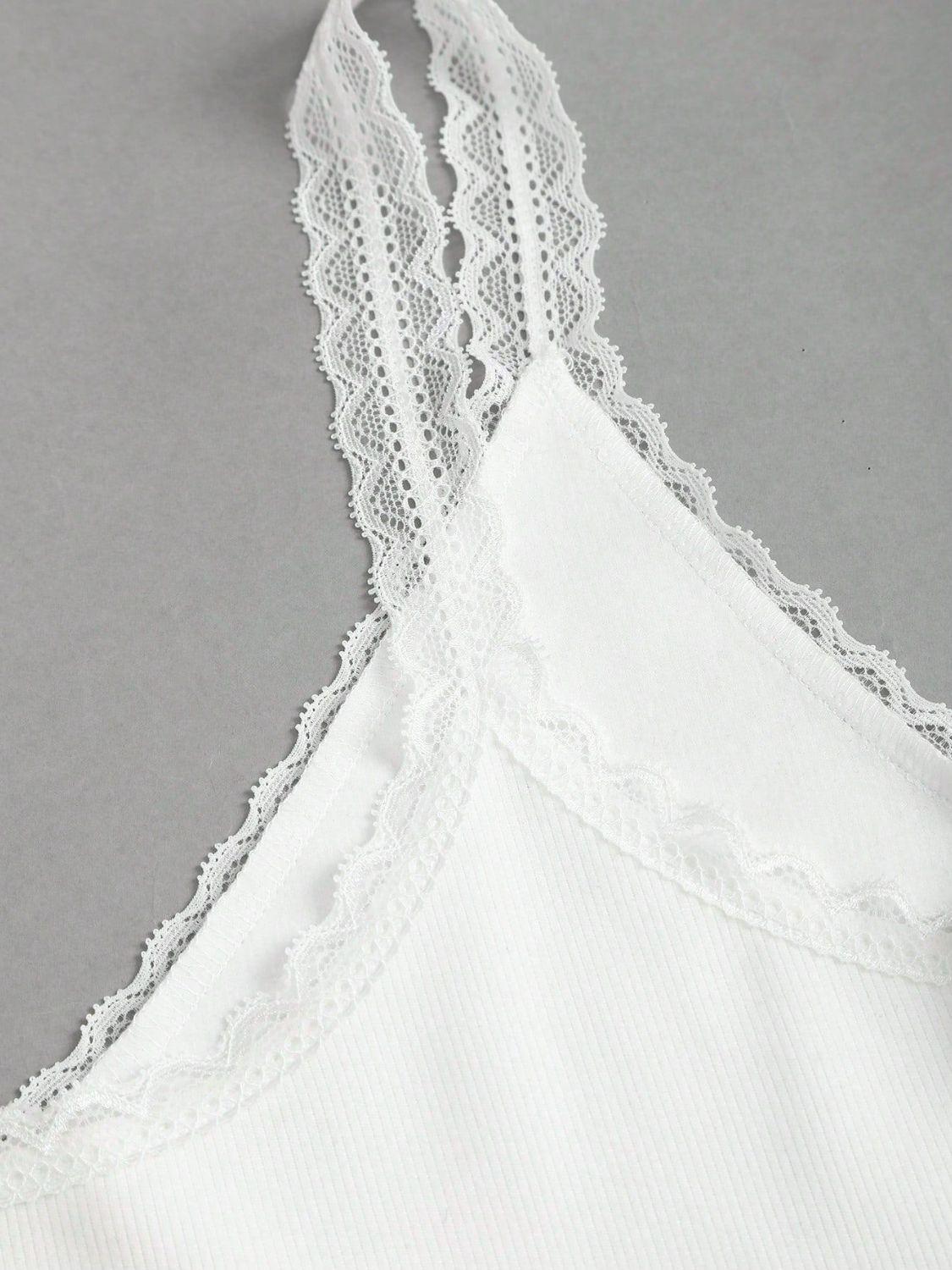 White lace cami with delicate lace trim on straps and neckline