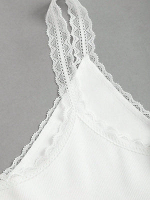 White lace cami with delicate lace trim on straps and neckline