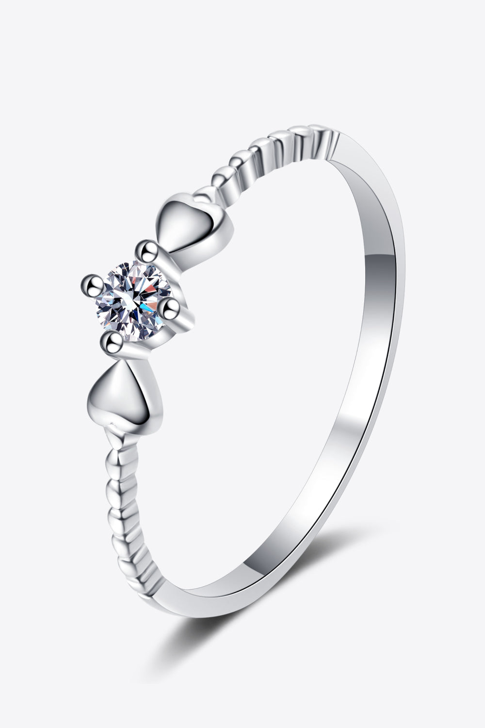 Silver ring with moissanite center stone and heart details