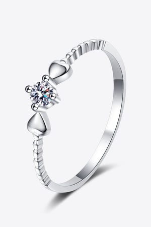 Silver ring with moissanite center stone and heart details