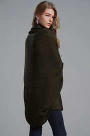 Olive green batwing knit cardigan with a textured pattern and draped front.