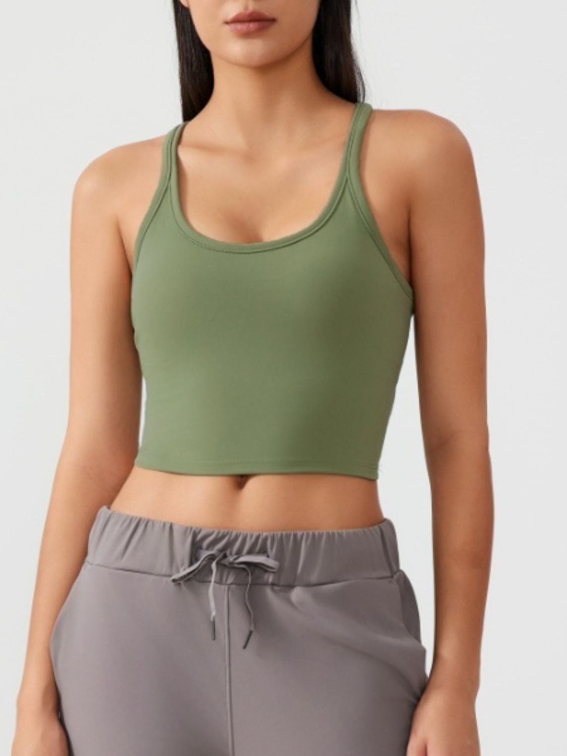 Sculpted racerback crop tank in moss green with a scoop neckline.