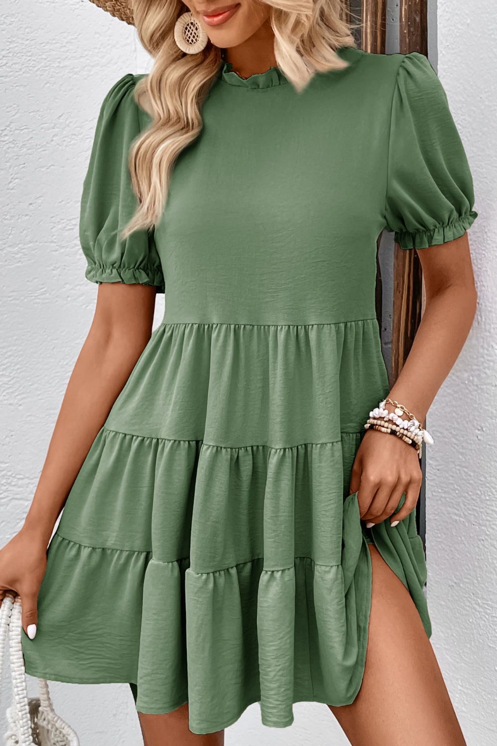 Matcha green tiered mini dress with ruffled neckline and puff sleeves.
