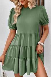 Matcha green tiered mini dress with ruffled neckline and puff sleeves.