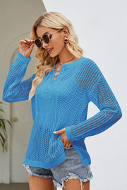 Sky blue openwork knit tunic with lace-up neckline and long sleeves.